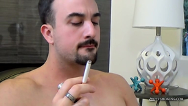 Mate with a goatee is jerking off while smoking
