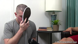 Sweaty muscular guy relaxes with a feet massage